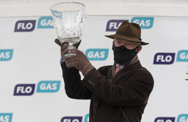 Champion trainer Willie Mullins lifts the winning trophy for Monkfish at the 2021 Flogas Novice Chase at the Dublin Racing Festival in Leopardstown. Photo: Patrick McCann/Racing Post.